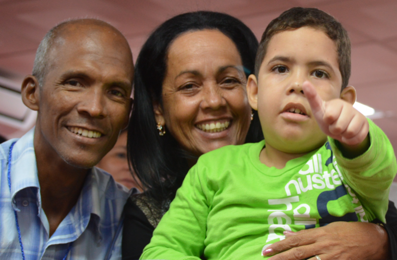49118047872_8919a28932_k-cropped three adults and a child smiling