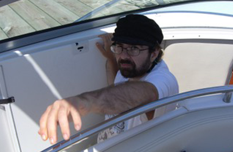 man wearing a black sailing hat on a boat