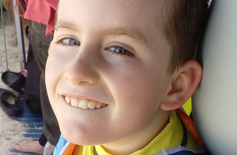 boy in yellow top smiling